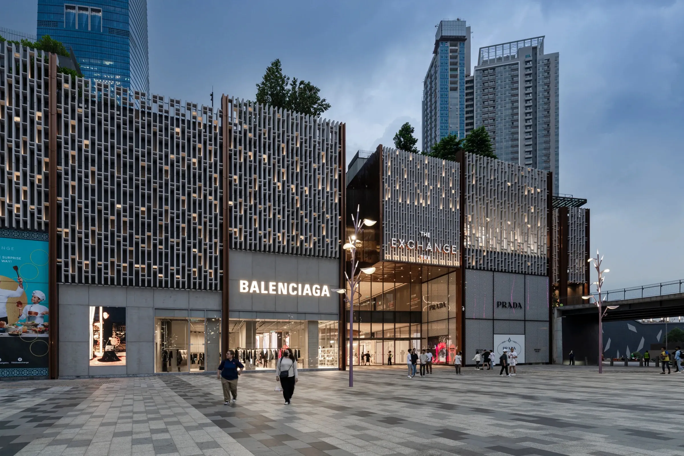 The Exchange TRX at dusk, with its patterned facade and luxury storefronts.
