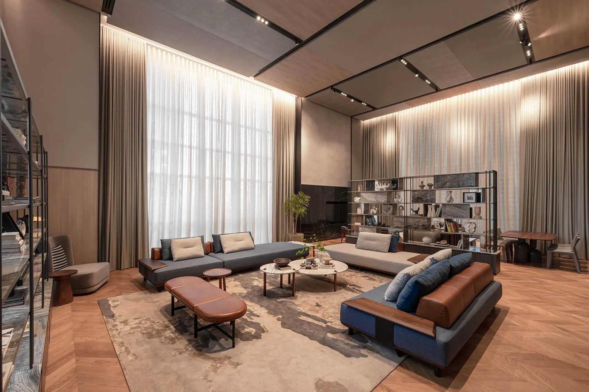 A double-height living space with full-height curtains and timber floors.